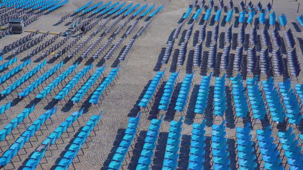 Long Rows of Blue Plastic Chairs for Spectators in Town