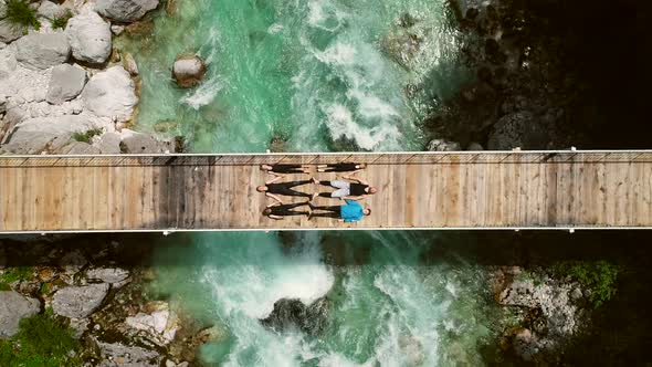 Aerial view of people lying on bridge over Soca river in Slovenia.