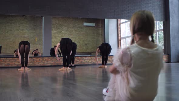 Little Girl Watching Ballet Lesson in Dance Studio