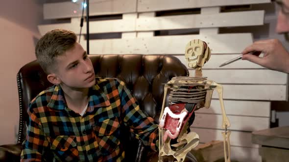 Young Student Listening To His Teacher Explaining the Structure of Human Body Organs