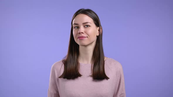 Cheerful Woman Showing Yes Sign Nods Her Head Approvingly