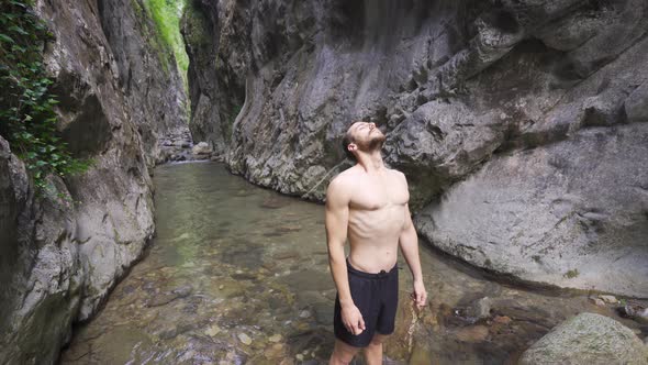 Athlete deep breathing. In nature in the canyon.