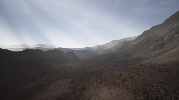 Sun Rays Over Mountains in a Valley