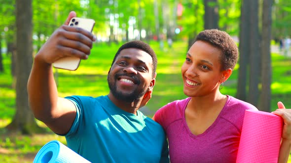 Latin American Couple Ready to Yoga Time Outdoors Pink and Blue Look Taking Self Portrait on Modern