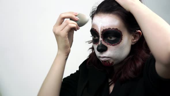 Girl Doing Makeup Skeleton for the Feast of Santa Muerte