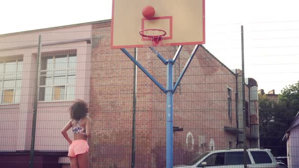 Young Woman Playing Basketball