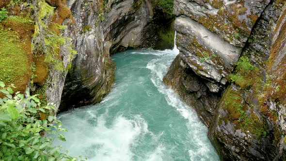 Stone Canyon In The Mountains Through Which Flows The Pure Turquoise River