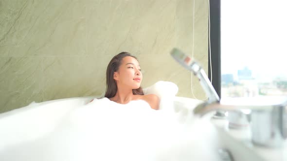 Young asian woman relax in bathtub