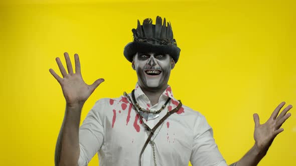 Crazy Man with Horrible Halloween Skeleton Makeup Appears From Bottom Side, Trying To Scare