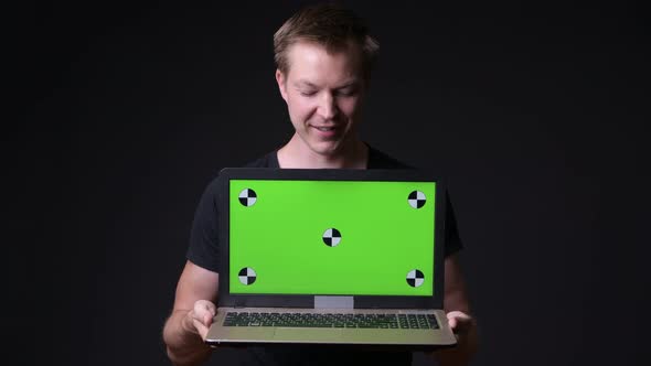 Young Handsome Man Using Laptop with Green Screen Chroma Key