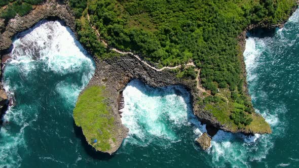 Secluded path on cliffs, Kesirat beach diverse shoreline, Indonesia, aerial view