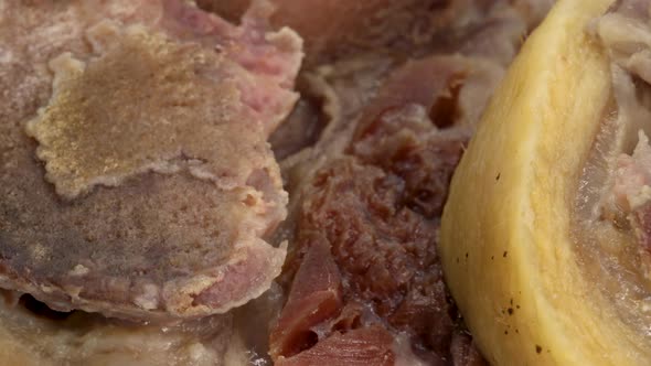 Close up, macro shot of cooked pork open bone cut. Bone, meat, fat, cartilague.
