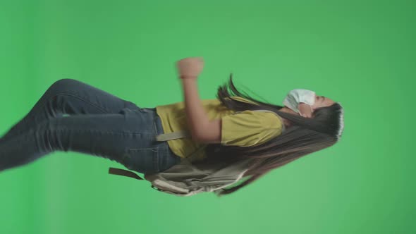 Side View Of Asian Girl Student Wearing Mask And Running To School On Green Screen Chroma Key