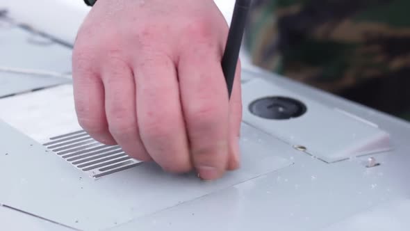 Closeup Shot Male Hand Screwed Remoted Control Antenna To Wing of Drone in Winter. Engineer Prepares