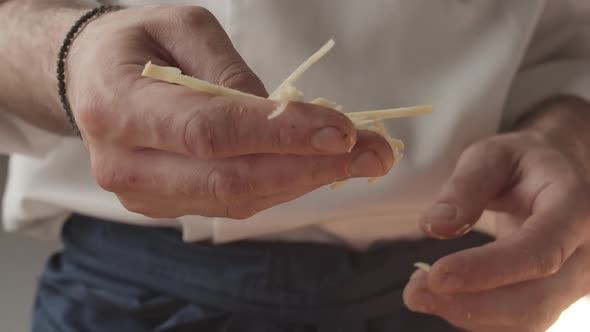 Chef Holds in His Hand Pieces of Ginger Select and Put Them in the Prepared Food