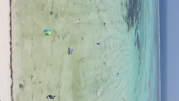 Vertical Video Kitesurfing Near the Shore of Zanzibar Tanzania Aerial View