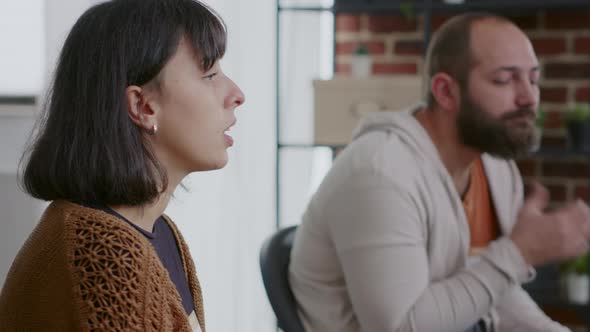 Woman Shaking Hands and Holding Cup of Coffee at Aa Group Therapy Session