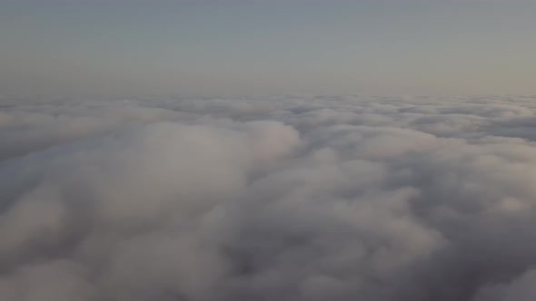 View From a Drone on a Sea of Clouds to the Horizon at Dawn