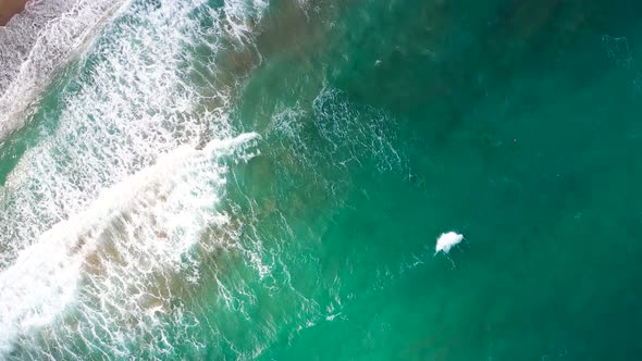 Aerial View of the Mediterranean Coast Waves Reach the Deserted Sandy Beach