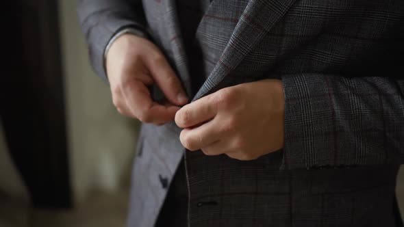 a Man Buttons on a Stylish Suit