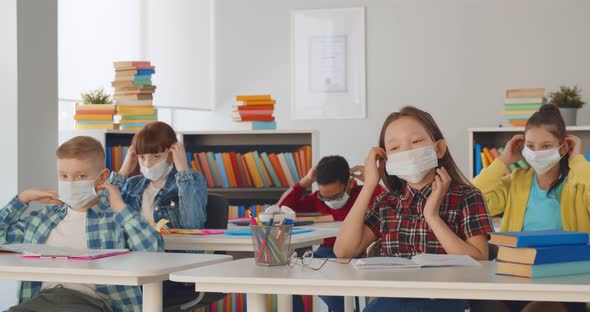 Multiethnic Children Students Wearing Medical Mask in Classroom