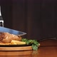Cut Off a Large Piece of Meat From the Pork Knuckle with a Knife. Very Fatty Junk Food. Knuckle on a - VideoHive Item for Sale