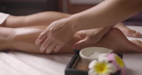 Woman Relaxing and Getting Massage on Legs By Female Therapist
