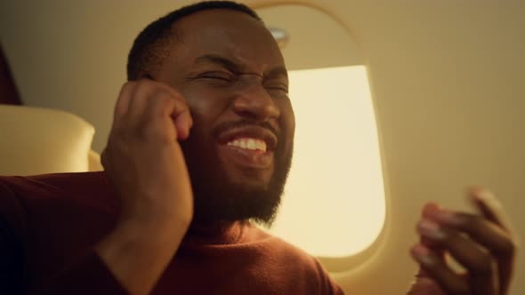 Joyful Man Calling Friend in Airplane Closeup