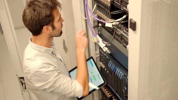 Network Engineer Working In Server Room. It Specialist On Computer Console PC. IT Technician Works.