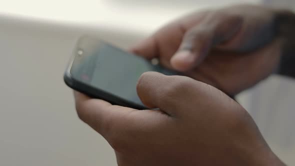 Close Up Shot of African American Student Using Smartphone.