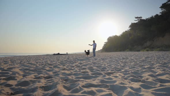 Man with Dog on Beach