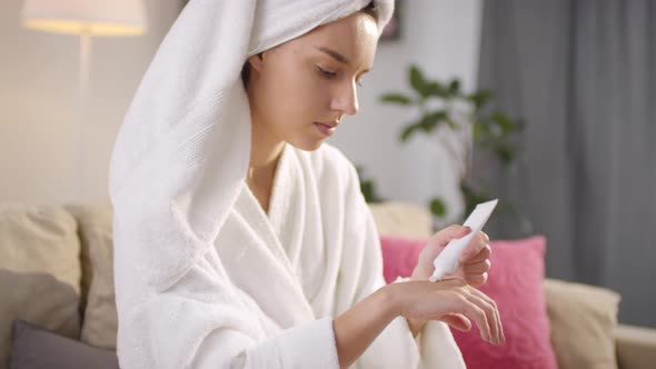 Young Woman Applying Hand Cream