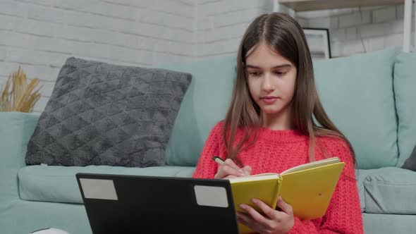 Beautiful Girl Making Notes of Online Lecture Lesson Sitting on the Floor Carpet