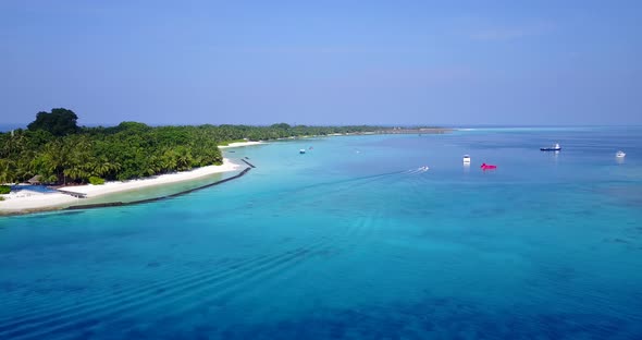 Wide angle above abstract shot of a paradise sunny white sand beach and blue ocean background in hig