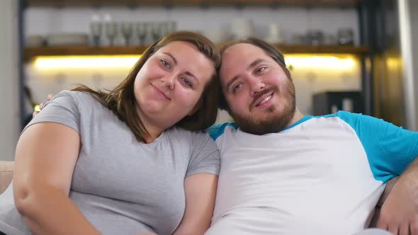 Overweight Happy Couple Watching Tv at Home