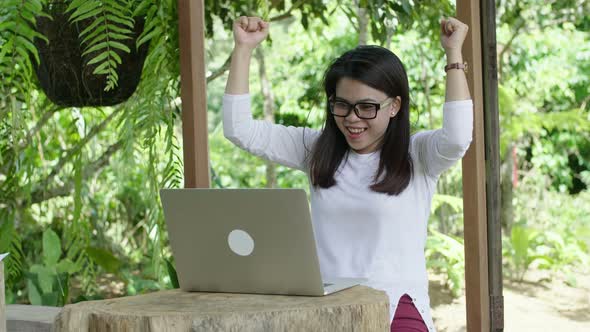 Woman With A Laptop Rejoicing