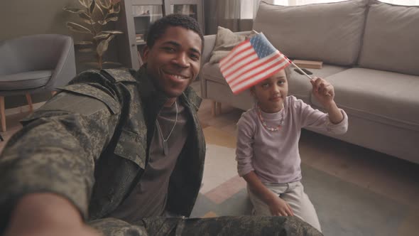 POV of Soldier and His Little Daughter with US Flag alt