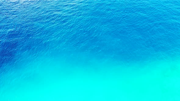 Tropical fly over travel shot of a white sandy paradise beach and turquoise sea background in hi res