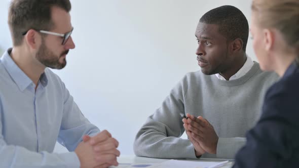 Professional African Businessman Having Discussion with Colleagues