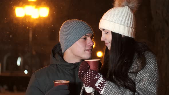 Two Loving People Pair with Hot Beverage in Hands Spending Xmas Evening Together