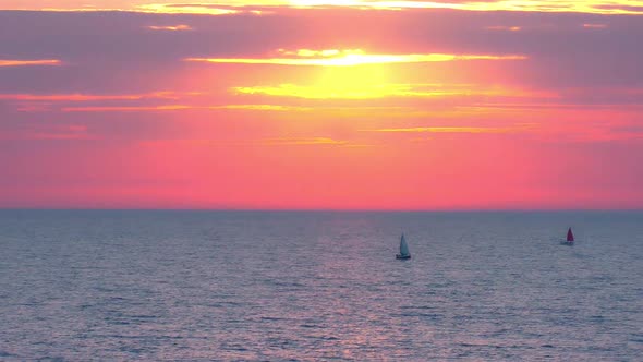 Sunset at Sea with Sailing Boats