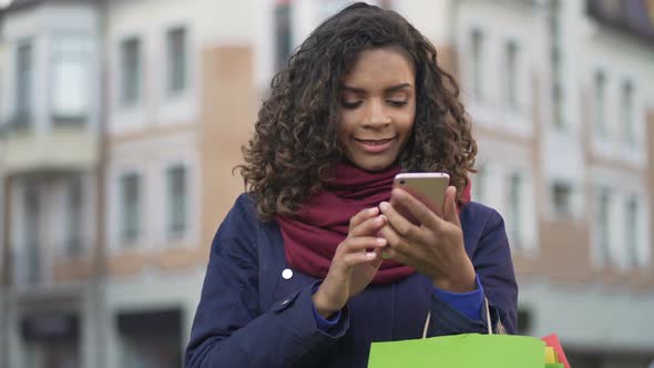 Stylish Woman Looking for Clothes, Actively Surfing Online Stores on Smartphone