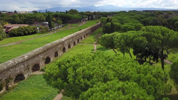 Biker And A Man Walking On The Trail In Parco Degli Acquedotti (Park of the Aqueducts) In Rome Italy