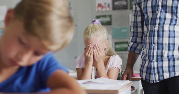 Video of african american male teacher supporting sad caucasian girl