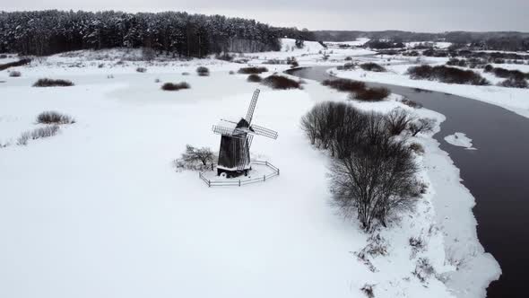 An Old Mill on the Banks of the River in Winter a Relative of Windmill Ecofriendly Energy