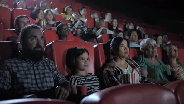 Mixed Race Family Watching Horror in Cinema