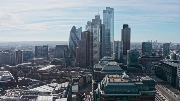 stationary Aerial drone shot City of London business district skyscrapers sunny day