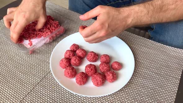 Man hands preparing meatballs