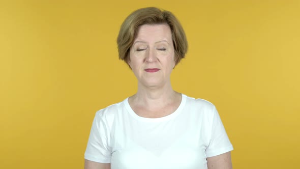 Old Woman Inviting Customers with Both Hands Isolated on Yellow Background