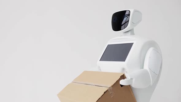 Humanoid Autonomous Robot with Cardboard Box in Hand. Cybernetic System Today. Modern Robotic